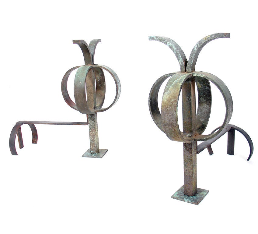 Pair of Sculptural Bronze Andirons, circa 1930's. They have a sculptural form that would fit seamlessly into any interior, from traditional to ultra modern. They are constructed of bronze with wonderful original verdigris patina.