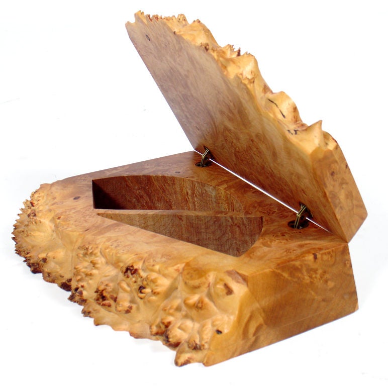 Hand crafted jewelry or stash box, made by Michael Elkan, circa 1980's. It is hand crafted using a beautiful piece of Oregon birdseye maple burl. It is comprised of two linear edges and one untouched, organically formed edge, with a hinged lid