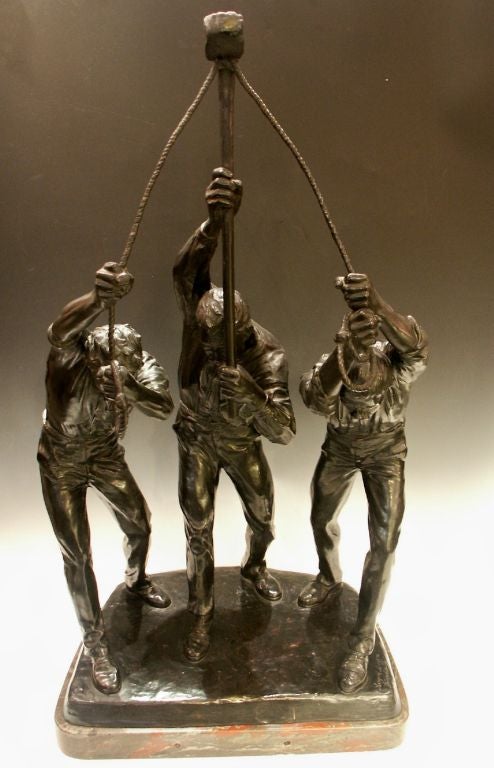 Massive bronze depicting three workers hoisting a hammer, possibly railroad workers.  This group effort exemplifies team work at its best.  Very heavy and impressive sculpture, with exquisite detail to clothing and the human form, it is executed in