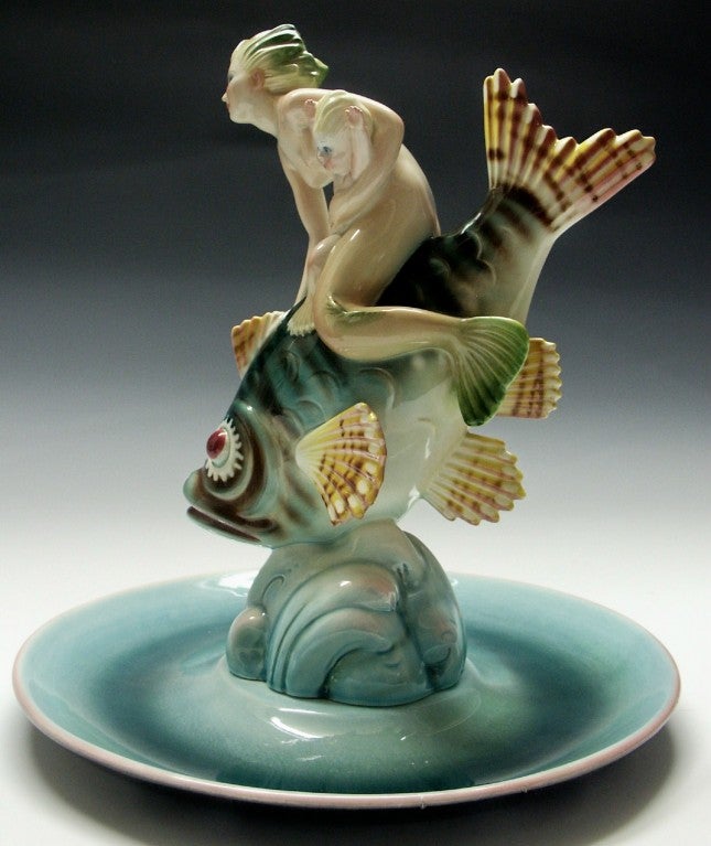 Wonderful depiction of a Mermaid with her baby riding a large colorful fish.  Most likely designed for the Lenci Company , Torino, Italy.  It is signed with illegible signature and Made in Italy. Also has its original selling price tag on the bottom