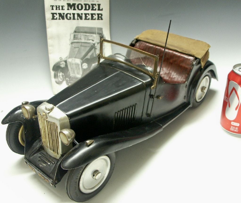 Exact replica of the real British car.  Includes an article in a model car magazine dated 1950.  Exceptional details throughout.  This  model car was built between 1945 & 1949. Made as a miniature copy of a real MG sports car of the period. The car