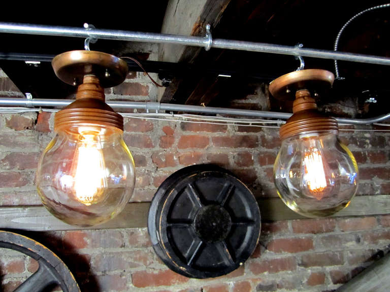 Threaded copper top stamped Benjamin, round glass globe, and ceiling mount. Elegant industrial statement.