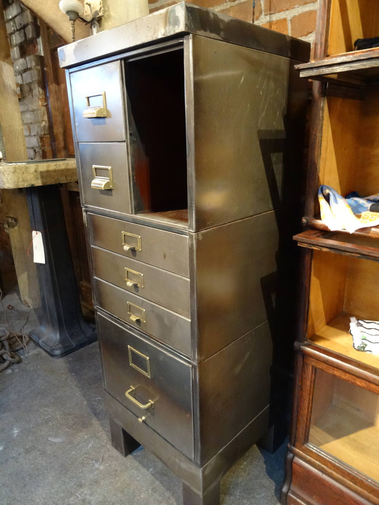 Industrial, steel, stacking cabinet.  Exterior has been stripped and finished, interior with original paint as shown in images.  Beautiful, multi-functional piece with brass hardware.  Cabinet consists of top, base and three stacking units.
