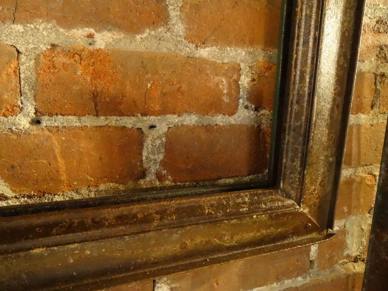 Galvanized steel window salvaged from an old Catholic school.   One side, as shown, has original hardware-hinges, chain and pulley.  Other side has formed steel, looking like crown molding, perfect for a frame.  Windows displayed are just examples