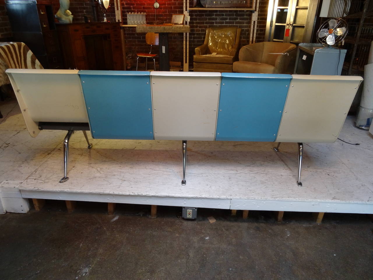 Five-seat, fiberglass, Brunswick Bowling Alley Bench.  Alternates blue and cream in color.  Fantastic!  Looks as if at one time it was attached to another.  Missing one back panel as shown in image 3.  Mid century homes are screaming for this piece