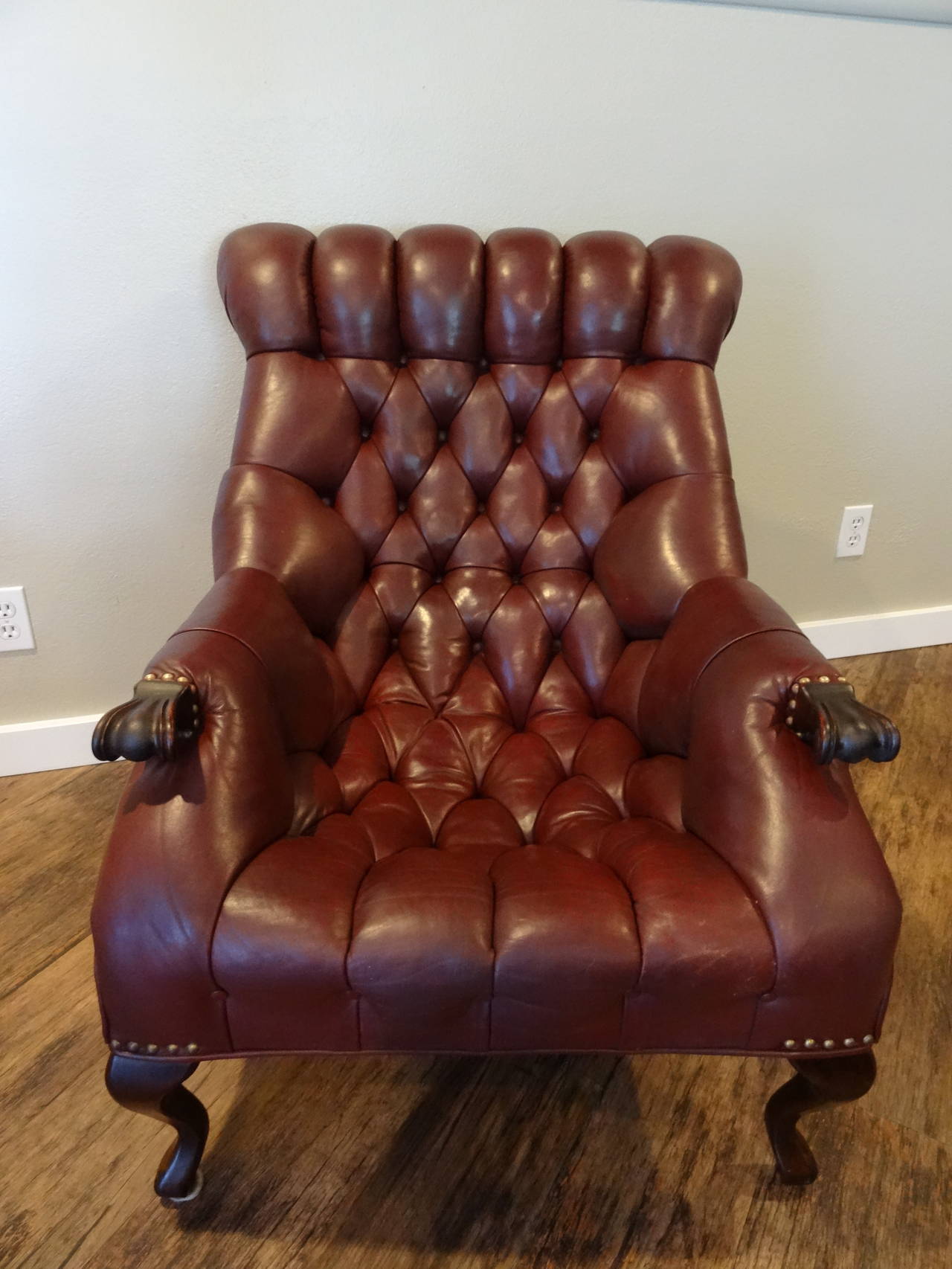 Rich, burgundy-brown, diamond tufted, leather chair and ottoman.  Made by Carl Forslund in the late 1960's.  Hand carved hands and cabriolet legs.  Ottoman 23