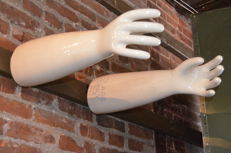 White porcelain glove molds. Great display, custom steel hangers. Height of molds varies from 7