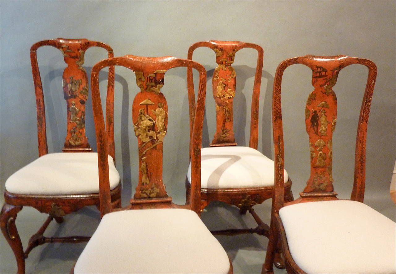 Rare Queen Anne period 18th century red lacquered side chairs. Four chairs wonderfully patinated with remarkable scarlet color and gilt chinoiserie decoration. Elegant curved backs with shaped bevelled vase-formed splats. Graceful cabriole legs
