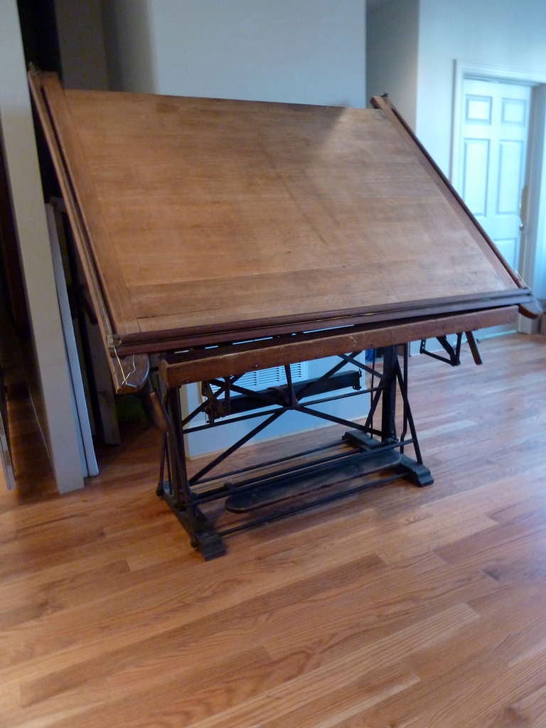  19th Century French Drafting Table.  Paneled top made of beech with trestle base made of steel with complicated weights and pulleys for adjustment to angel of the top. Made in Paris circa 1880