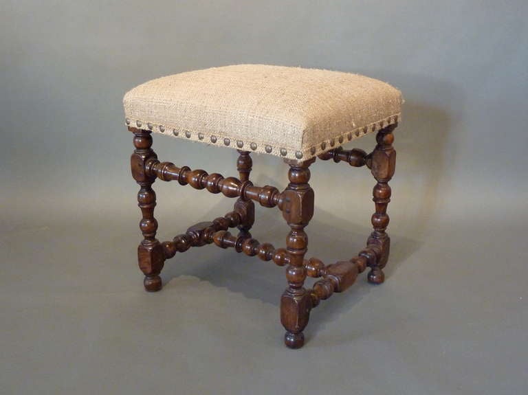 Louis XIII Period 17th Century French Provincial Stool. Made of deeply patinated walnut with a rich lustrous color. Good proportions with intricately turned legs and stretchers typical of the period. Made in France circa 1650.