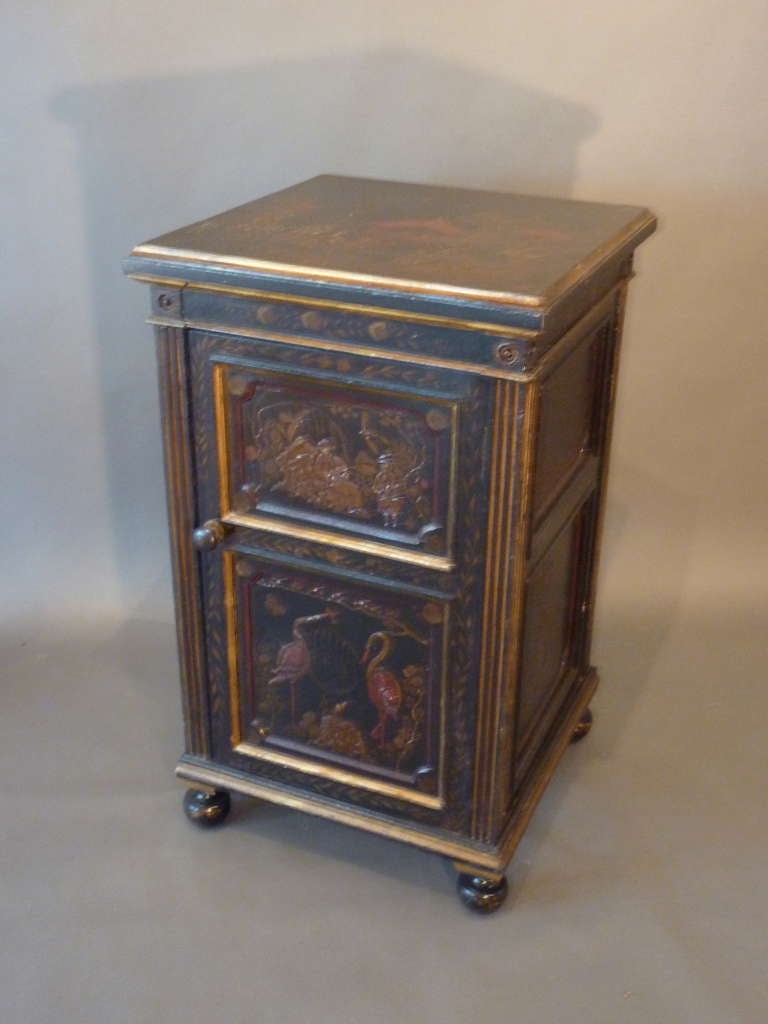Made of Mahogany with finely executed gilt and painted Chinoiserie decoration.  Fluted pilasters fram a moulded and paneled door over turned feet.  Both the decoration and cabinetry are unusual high quality.  Made in France circa 1840.