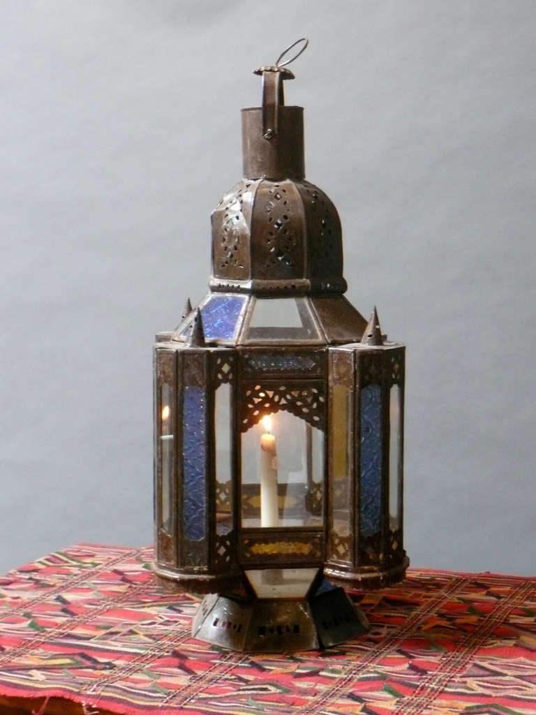 Moorish Style North African lantern. Made of sculpted tin with pierced decoration and colored glass panels. Made in Morocco circa 1960.