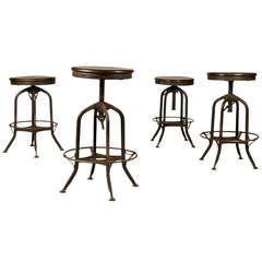 A Set of Four Toledo and Company Industrial Metal Stools