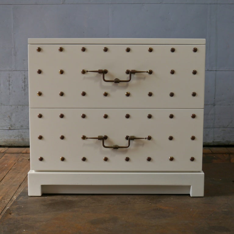 Tommi Parzinger studded 2 drawer night stand.  White lacquer with brass hardware.