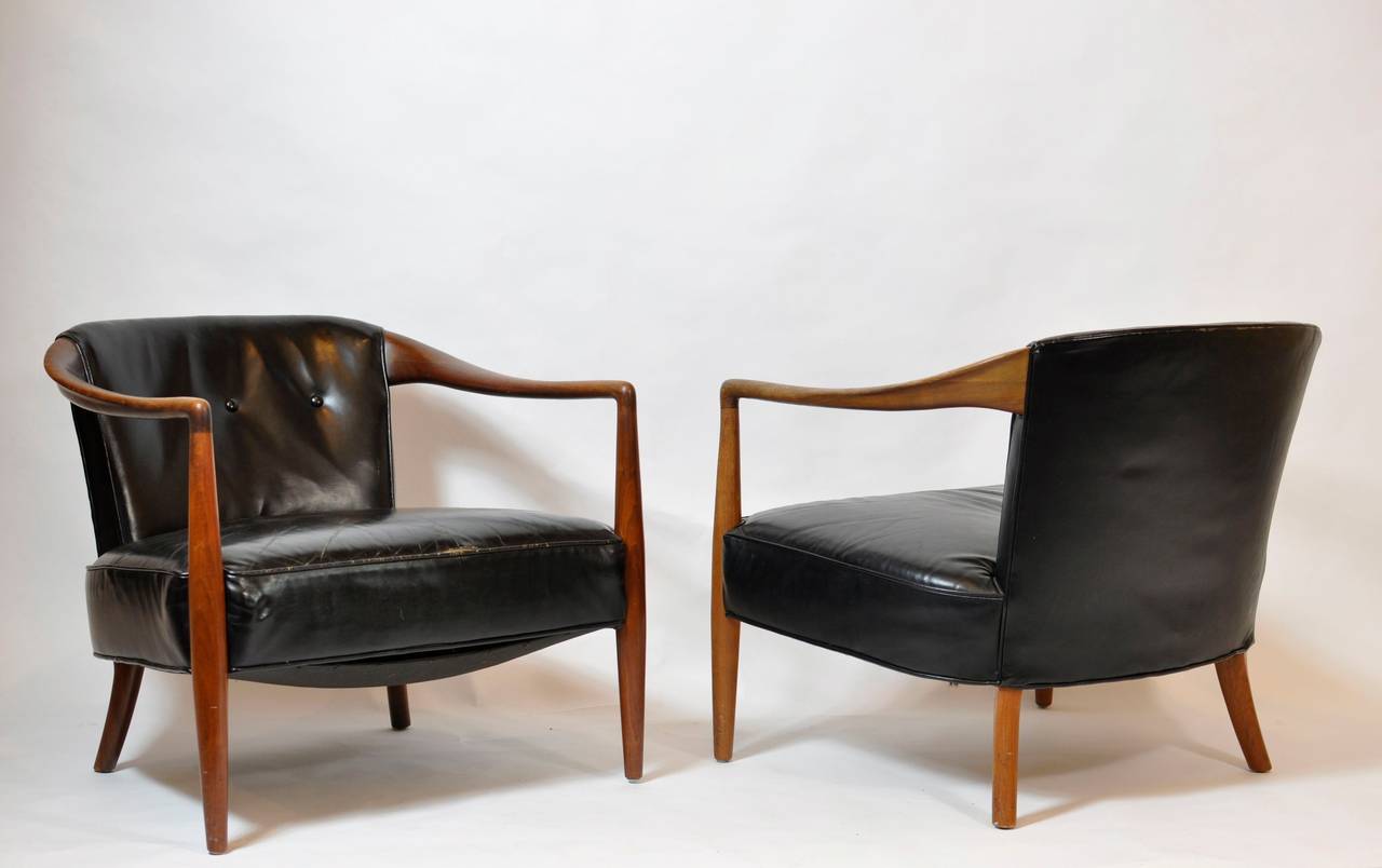 Sculptural leather lounge chairs. Beautifully crafted lounge chairs with original black leather.