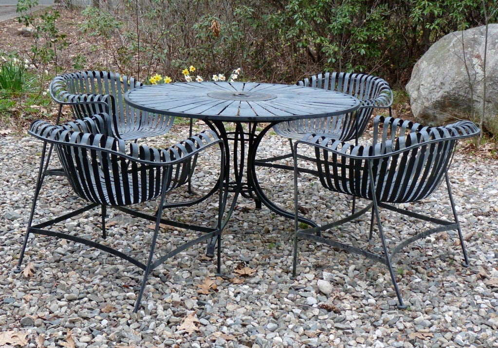 Iron patio table and four large scale chairs.