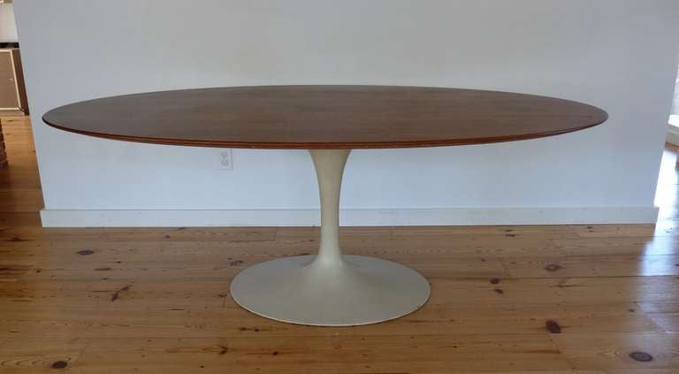 Eero Saarinen walnut oval top dining table for Knoll with  tulip pedestal base.