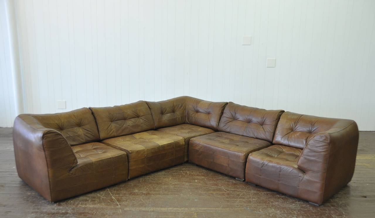 Vintage De Sede 5 Piece Leather Sofa.  Patchwork brown leather nicely worn.  Great scale and comfort. Each 3 piece section measures 9 ft long.  Sofa is 3ft deep X 29