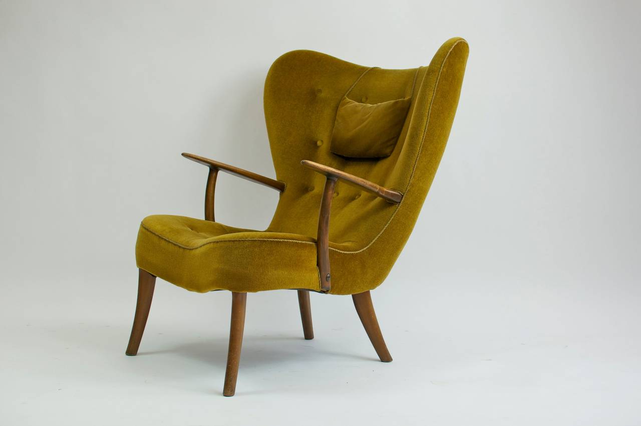 Madsen and Schübel Pragh sculptural lounge chair. Beechwood, velvet upholstery, brass joinery.