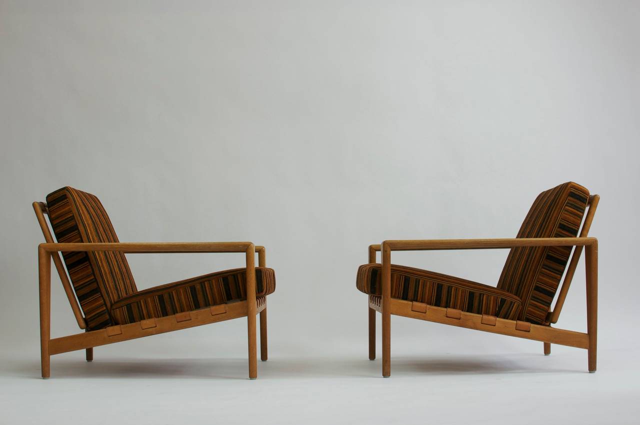 Pair of Svante Skogh lounge chairs. Simple clean lines. Wonderful warm patina in the oak frames and beautifully aged leather strapping. Excellent quality.