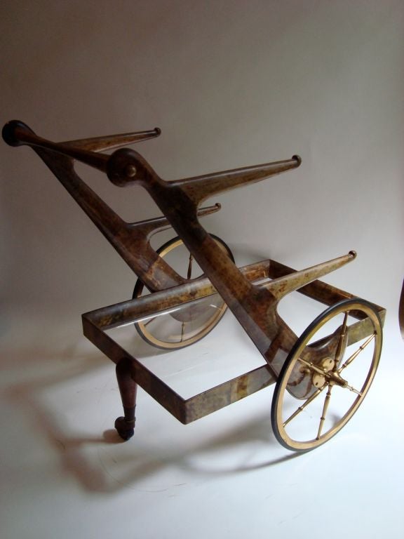 Aldo Tura Goatskin bar cart with brass spoke wheels and two removable trays with brass handles.