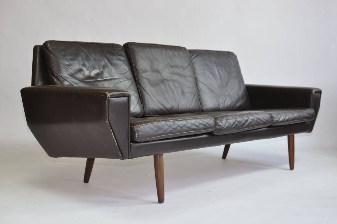 Danish leather sofa with teak legs.