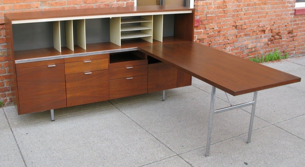One of the most iconic and elaborate of George Nelson's mid 20th century office storage designs for Herman Miller, this large credenza/ desk combination has large amounts of storage as well as several work surfaces in addition to the large desk. the