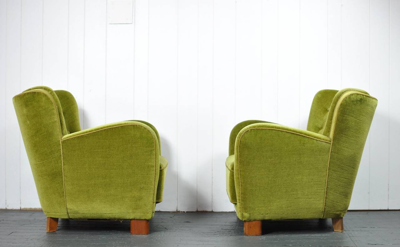 Pair of 1930s Danish lounge chairs attributed to Fritz Hansen. Green velour, oak front legs, stained beech back legs.