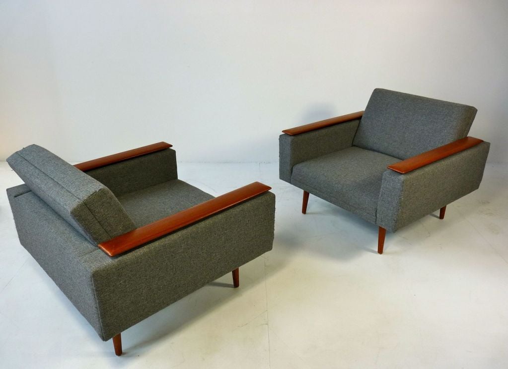 Danish Modern sleek low lounge chair with teak armrests.