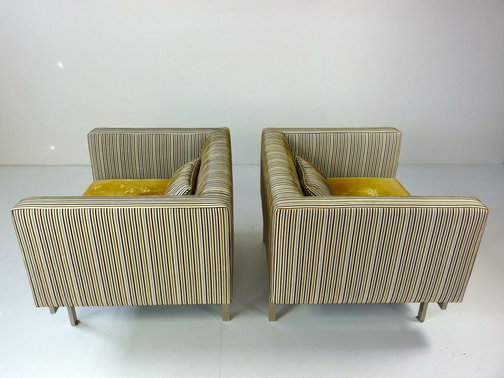 Large scale mid century lounge chairs.  Unique floating seat and well crafted matte steel base.