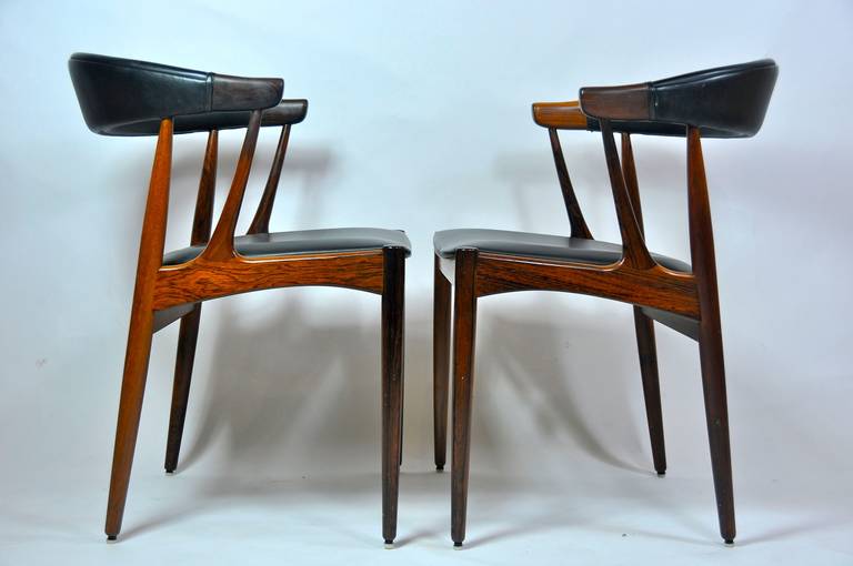 Pair of sculptural rosewood Danish chairs. Vinyl seats.