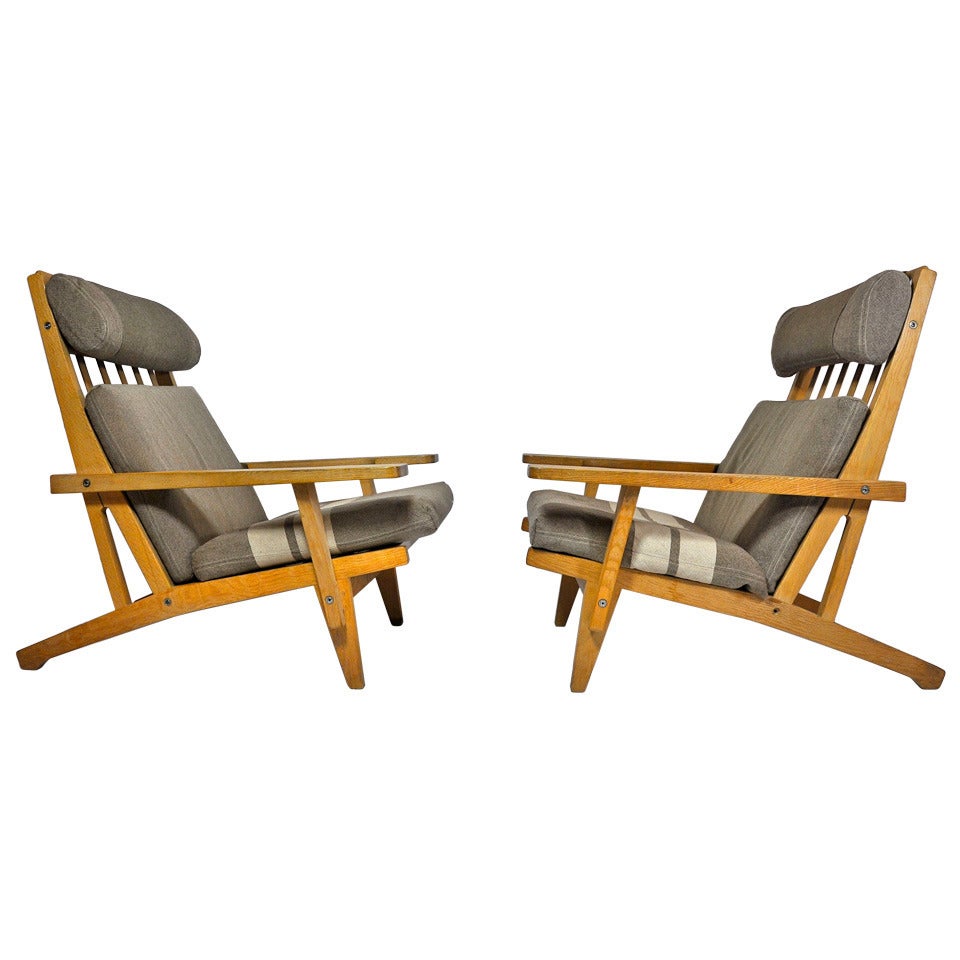 Pair of Wide Arm Lounge Chairs and Ottoman by Hans Wegner