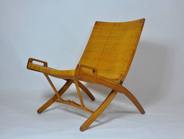 Hand Wegner folding lounge chair with cane seat and back.