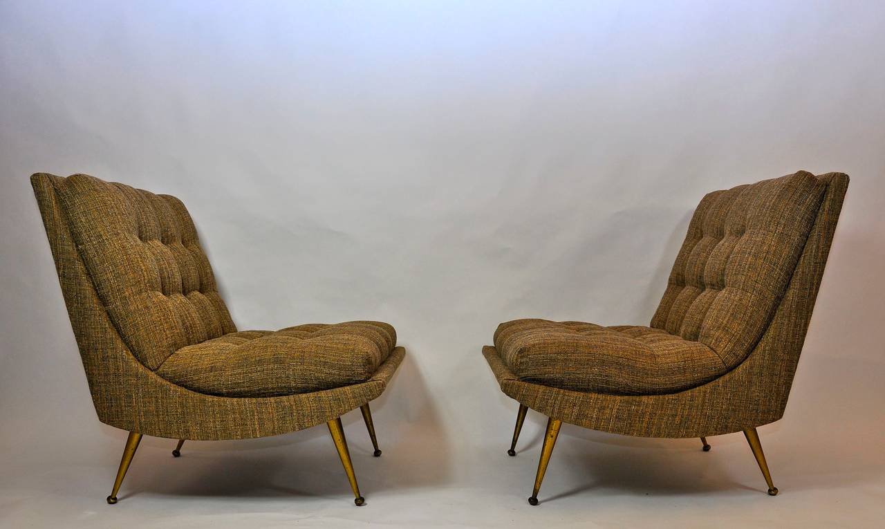 Pair of Italian lounge chairs with brass legs.