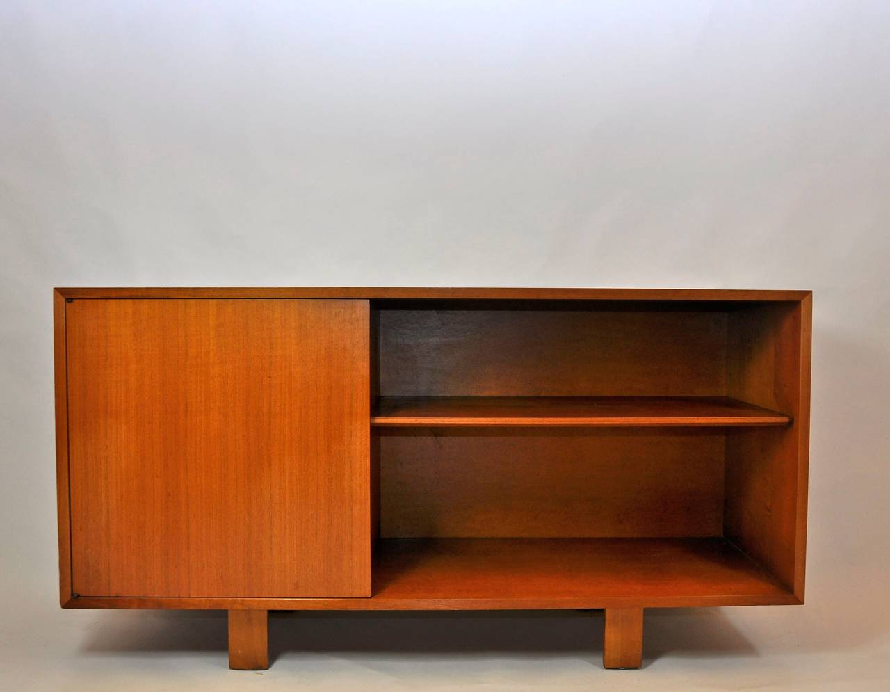 George Nelson cabinet for Herman Miller with open bookcase and concealed shelf.