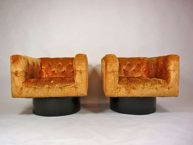 Pair of swivel cube lounge chairs.