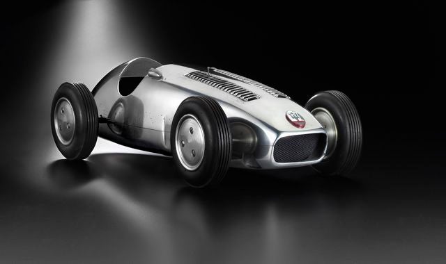 A rare and superb Maserati petrol-powered aluminum tether car borrows elements from both the Maserati 4CLT/50-Milano of 1951 and the more famous 250F of 1954, both quintessential 1950s Grand Prix cars. <br />
<br />
Attributable to maker