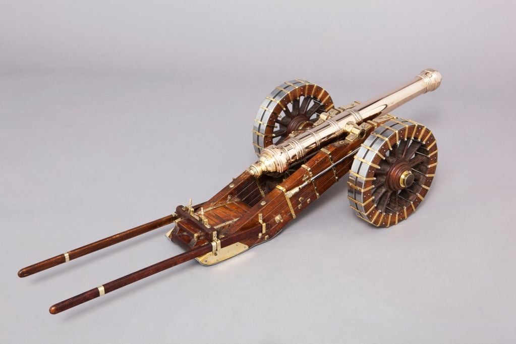 A highly detailed and decorative model of a Seventeenth Century fortification cannon. The oak field carriage is brass mounted and the wheels are reinforced with brass and steel banding.  Removable brass bound oak poles, two removable brass pins, one
