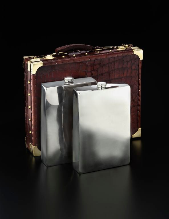 An antique crocodile skin-covered Prohibition Case containing a pair of gallon size drinking flasks designed by James Dixon & Sons of Sheffield for Abercrombie & Fitch Co., New York.<br />
<br />
It was a well known fact that, during the 1920s,