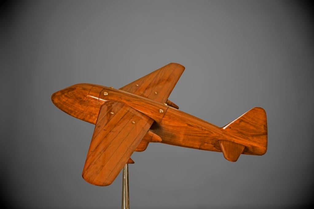 A rare and finely made laminated mahogany wind tunnel model of a twin-engine pusher airplane attractively mounted on a brass and aluminum stand.