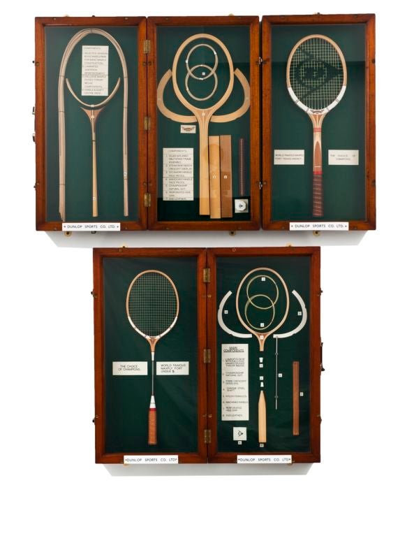 A complete and unique set of highly decorative portable teak display cases containing Dunlop Maxply tennis and badminton racquets.