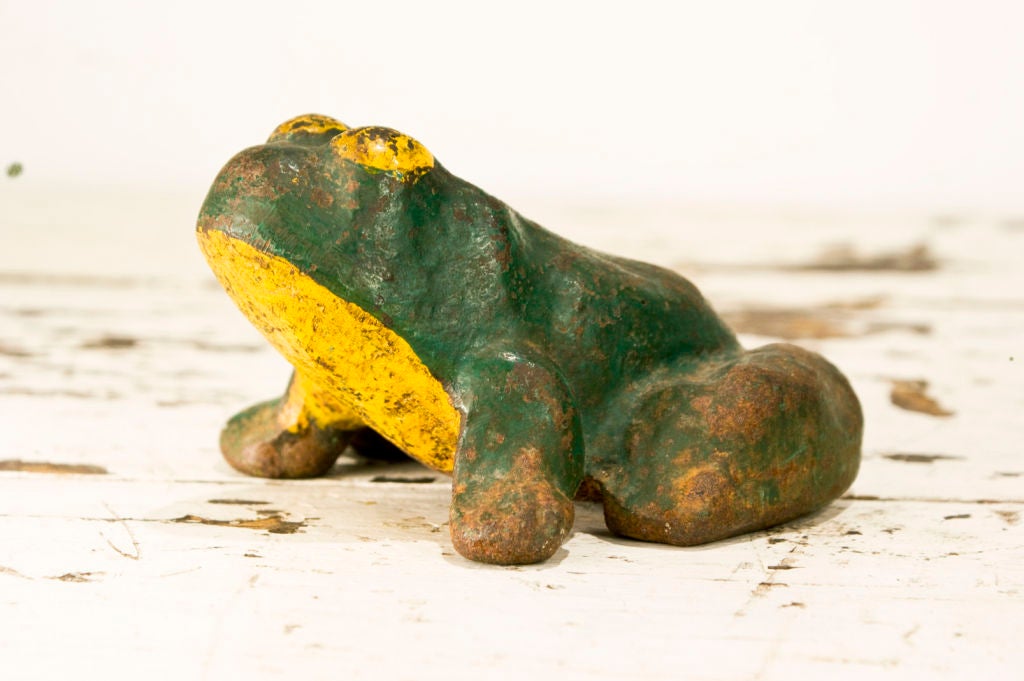 Early cast iron frog door stop with layers of great original paint.