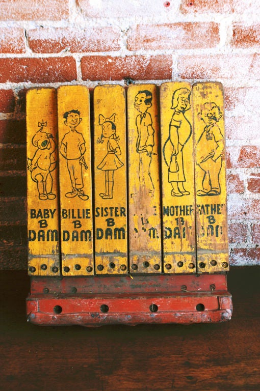 Meet the B Dam Family. Each member is depicted on his/her own yellow painted knock down in simple black outline 'sketches.'   C. 1940's Carnival softball knockdown midway game.  These were salvaged from the Arnold's Park Amusement Park in Okoboji,