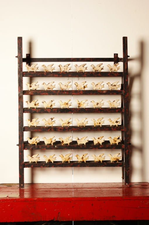 This c. 1920's H.C. Evans shooting gallery has 36 birds on the six racks, all with original paint surface. A lever on the right side of the rack pulls down to reset the targets. <br />
<br />
This gallery came from a very important and published