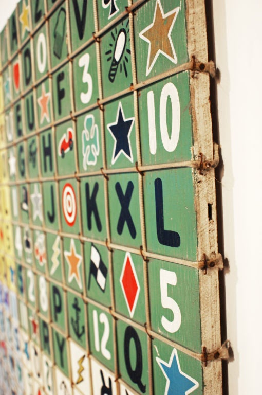 This c. 1930's carnival midway game board features a stapled rope grid of numbers, letters, and symbols.