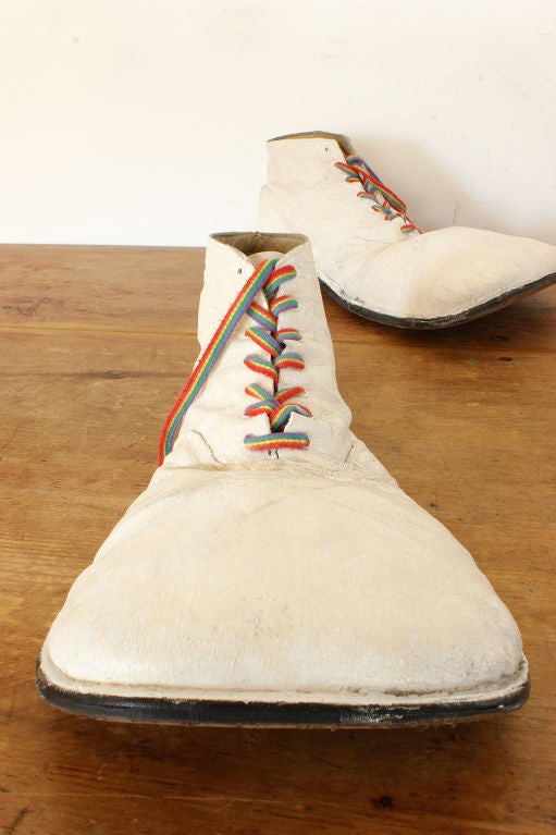 An amazing pair of c. 1950's clown shoes with several layers of original white paint and rainbow laces from the 1970's. Found in Florida.