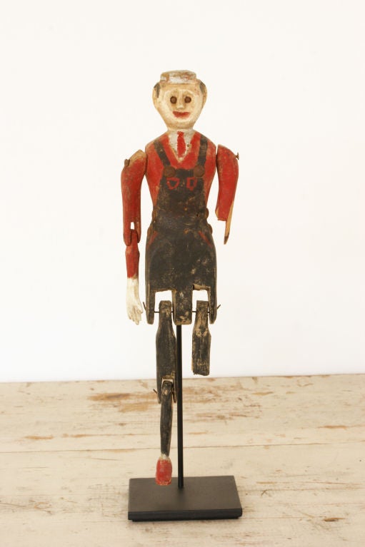 Late 19th century articulated figure with a nicely detailed carved face, navy overalls and red-painted shirt, tie, and shoe.
