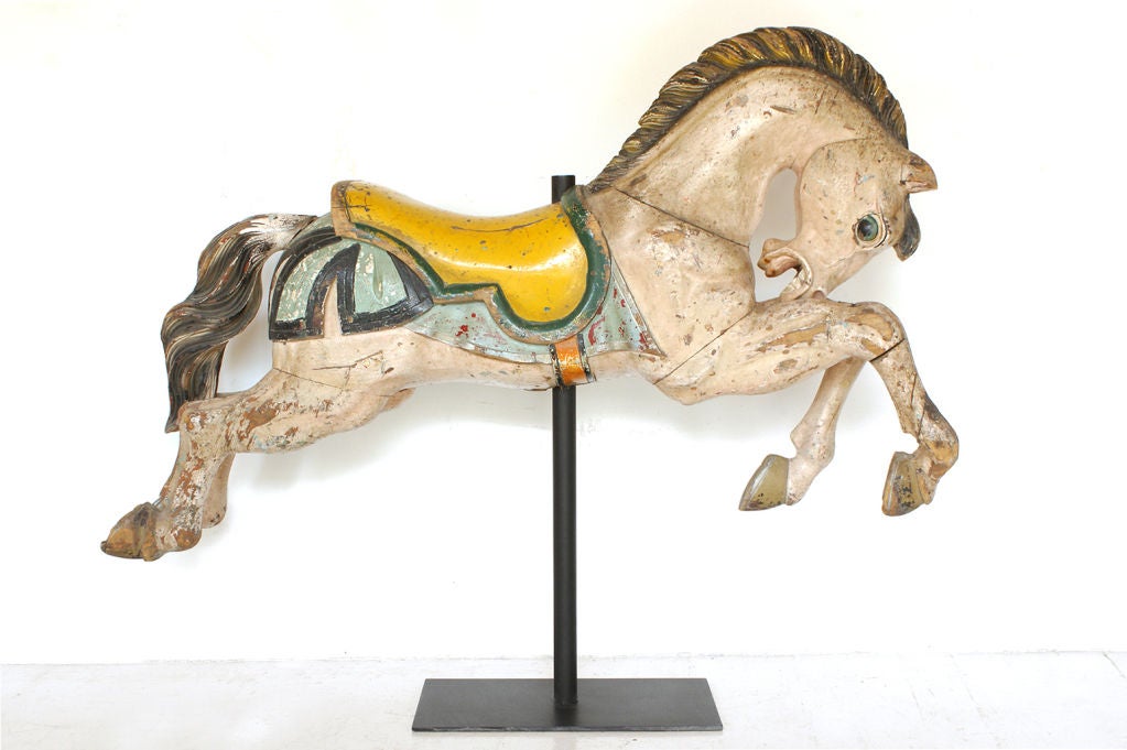 Dynamic carved carousel horse from the studio of Luis Ortega in Puebla, Mexico. Original park paint. Presented on custom museum iron stand. Horse lifts off stand for ease of transport and moving. Please note, the set of two is the horse and the