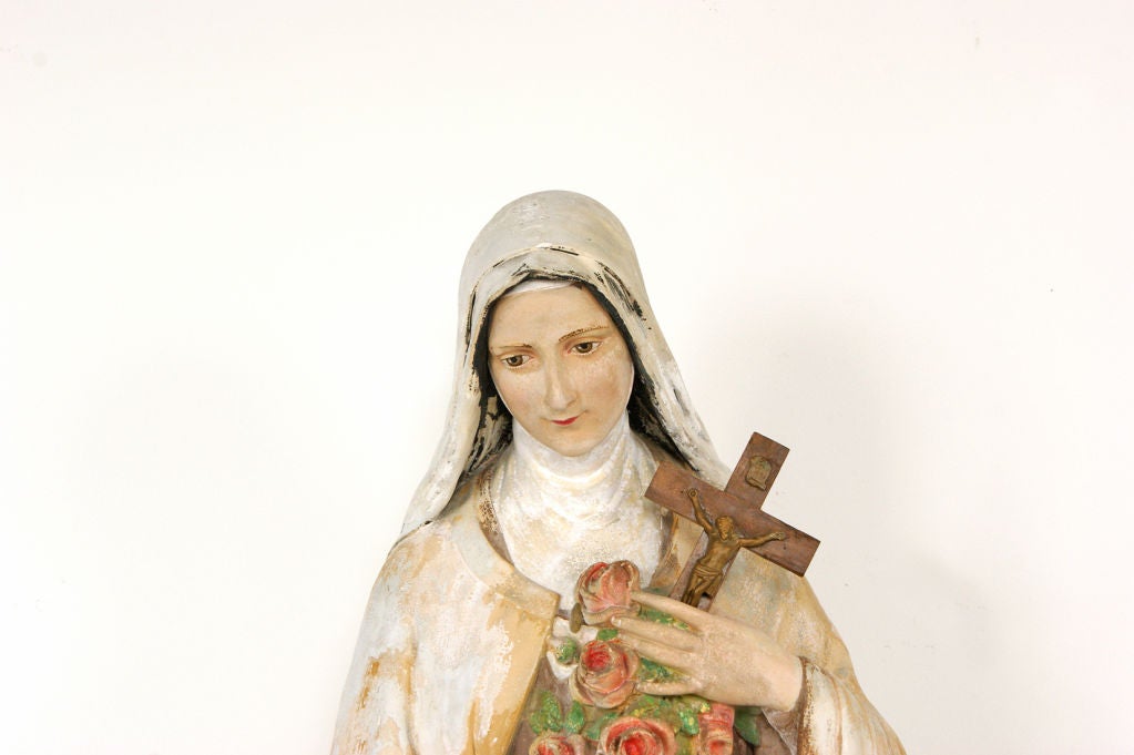 This turn of the century chalkware devotional bust, with its original paint surface, depicts Saint Therese of Lisieux holding a bunch of roses and a crucifix. From a Catholic Church in Erie, PA. 



Made of sculpted gypsum, chalkware was popular