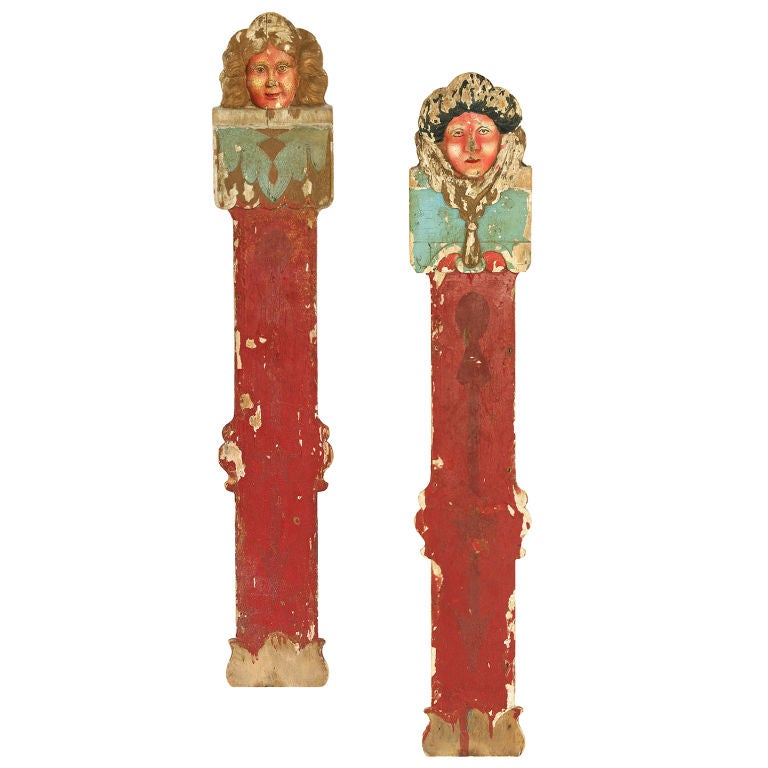 Pair of American 19th century circus wagon or traveling carousel three-dimensional wood carved faces. From an early American traveling circus. Many layers of paint and patina. Each is numbered on the back for ease of set-up and take-down. We have